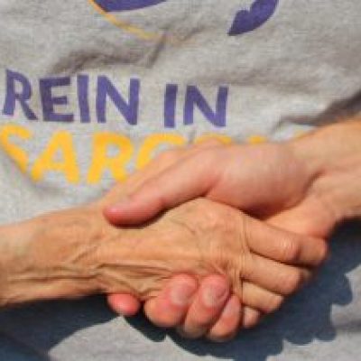 Volunteer hands over RIS logo